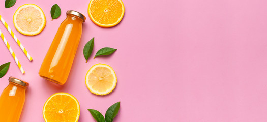 Flat lay composition with glass bottles of juice or fresh, slices of fresh lemon and orange, green leaves, cocktail tubes on pink background top view copy space. Citrus Juice Concept Vitamin C Fruits