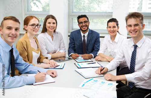 Young business people smiling looking at camera