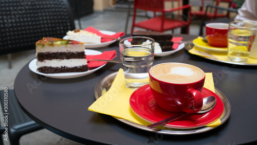 Breakfast with cappuccino and cakes in a summer cafe