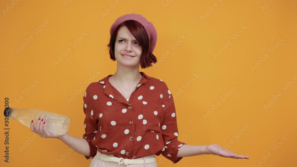 Attractive young caucasian woman having bottle over isolated yellow background annoyed and frustrated, looks disappointed, confused