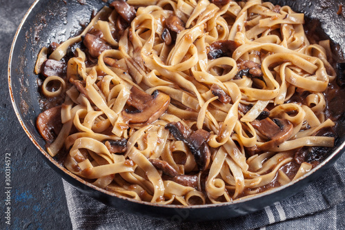 Tagliatelle pasta with champignion mushrooms photo