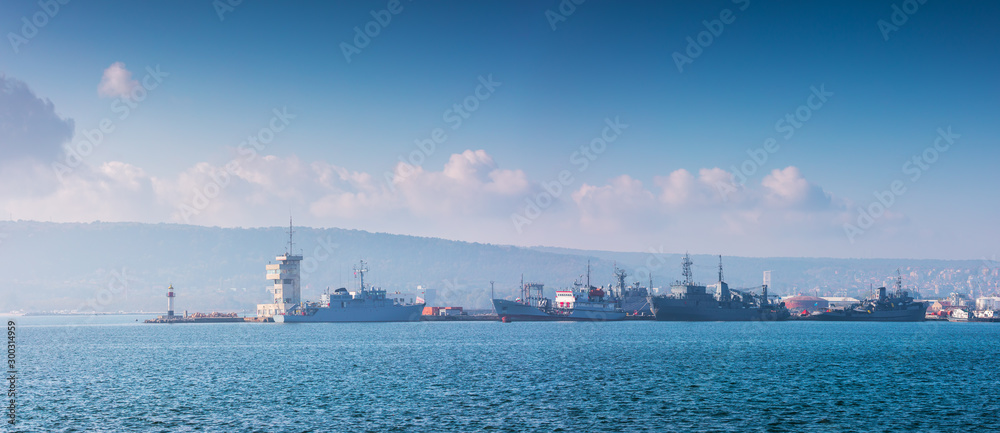 Sea port Varna, Bulgaria and beautiful morning landscape. Cargo ships, industrial cranes and navigation tower