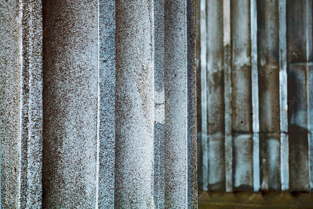 Fototapeta premium Fragment of antique columns background. Selective focus.
