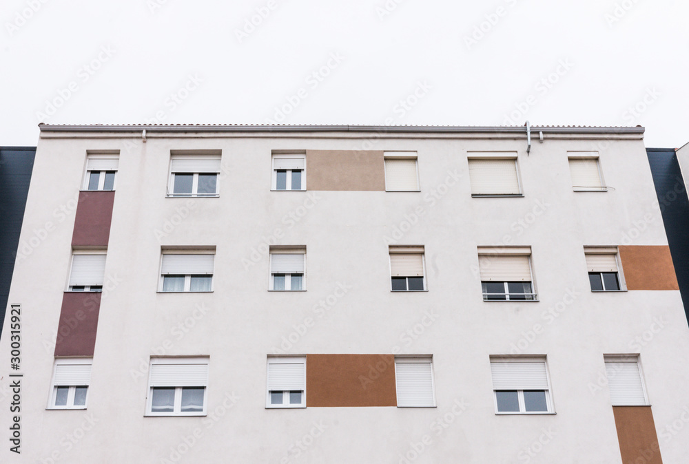 Fototapeta premium white facade with windows in residential building