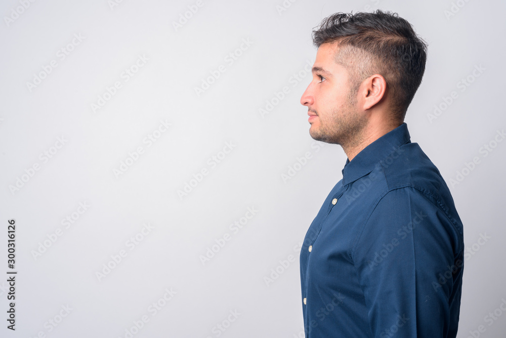 Closeup profile view of young handsome Persian businessman Closeup profile view of young handsome Persian businessman