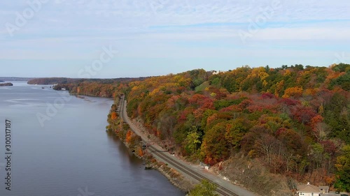 Aerial view of train tracks on Hudson River with colorful Autumn foliage photo