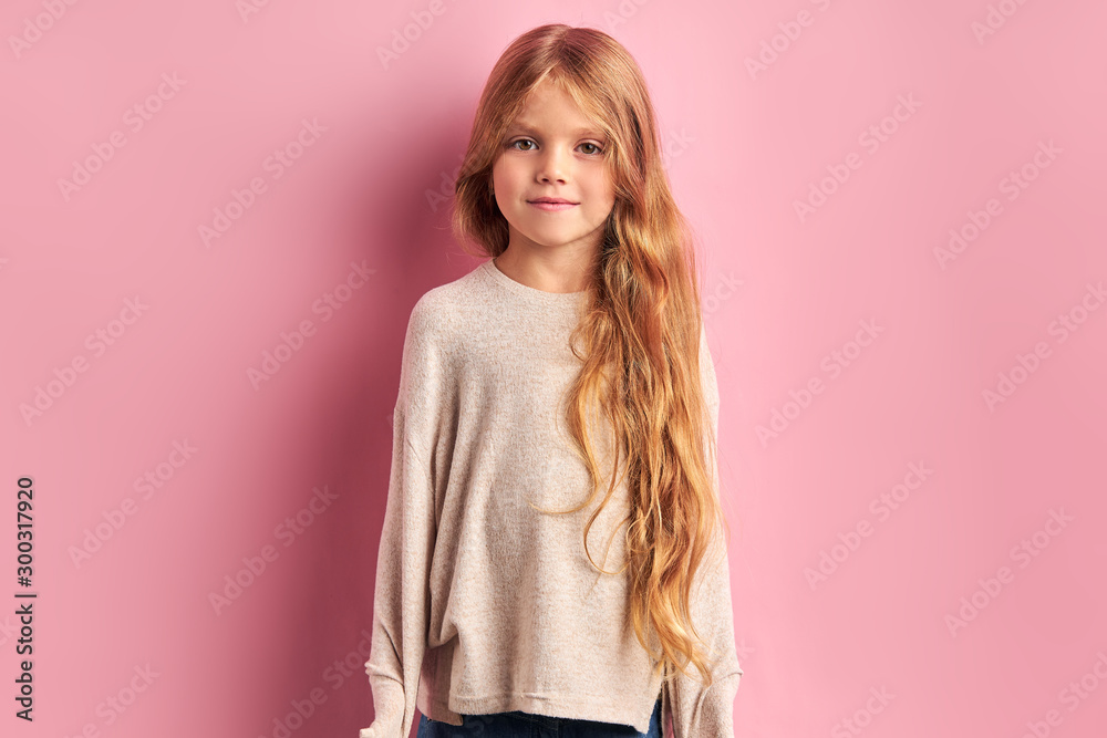 Portrait of quiet little girl wearing white blouse, long haired giel look at camera. pink background Portrait of quiet little girl wearing white blouse, long haired giel look at camera. pink background