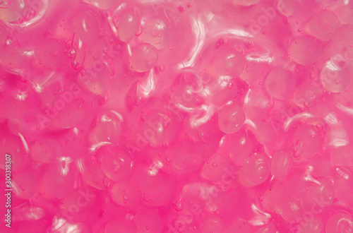 shiny pink slime texture with eggs inside. pink light with a wet sheen