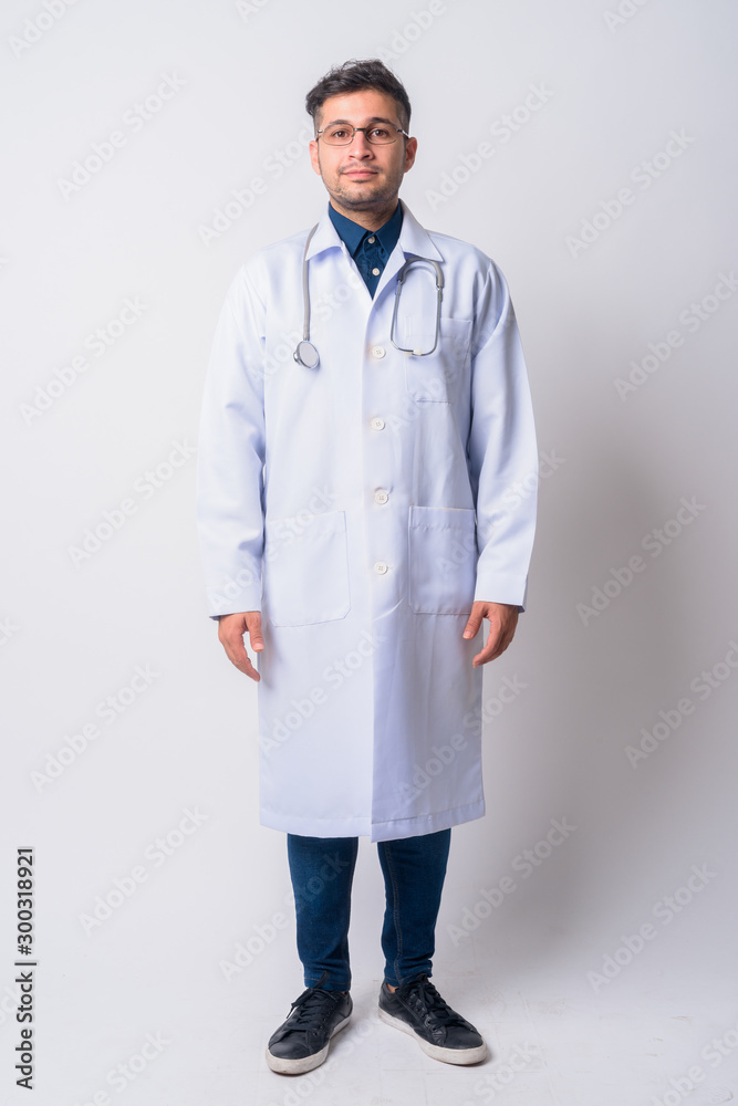 Full body shot of young Persian man doctor Full body shot of young Persian man doctor