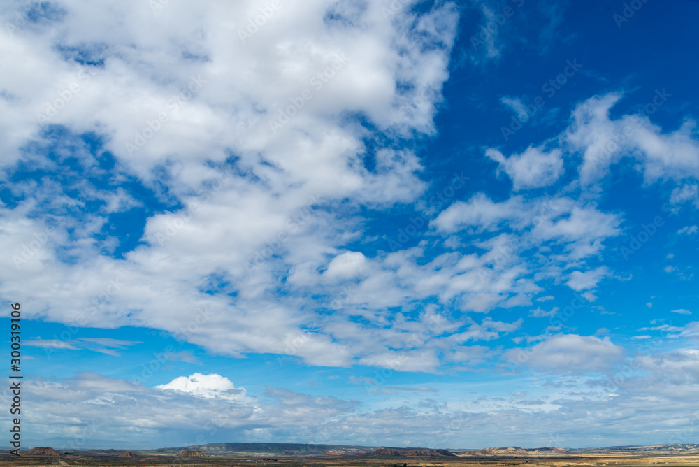 Spring sky with clouds above the badlands Bardenas Reales in the southeast of Navarre