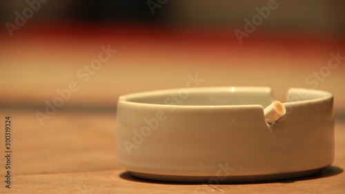 cigarette ashtray on the table, in a photo with a blurry background and selective focus