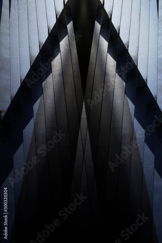 Metal grid, lath or louvered structure of girders. Abstract construction and architecture photo with polygonal pattern and parallel lines. Closeup of industrial building exterior or interior framework