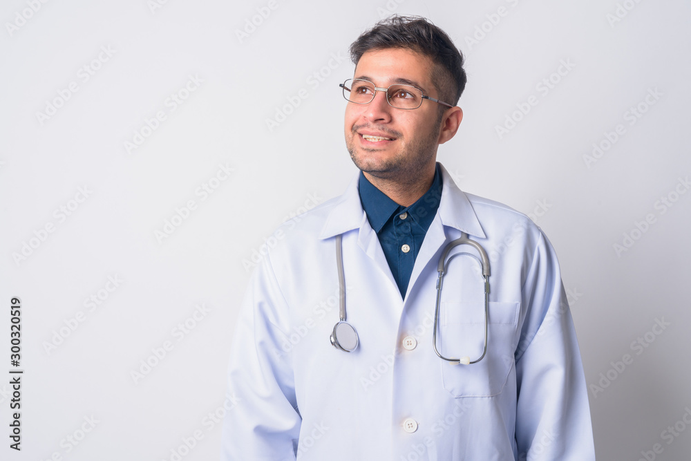 Portrait of happy Persian man doctor thinking Portrait of happy Persian man doctor thinking