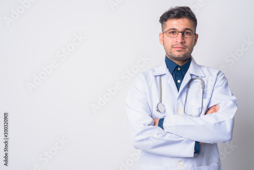Portrait of young Persian man doctor with arms crossed © Ranta Images
