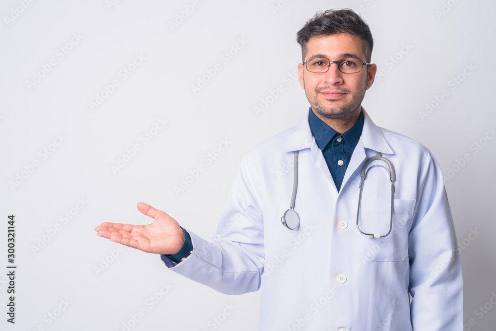 Portrait of young Persian man doctor showing something Portrait of young Persian man doctor showing something