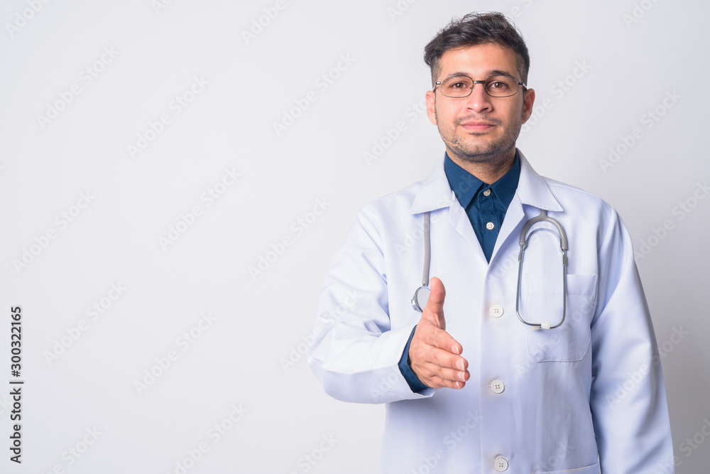 Portrait of young Persian man doctor giving handshake Portrait of young Persian man doctor giving handshake