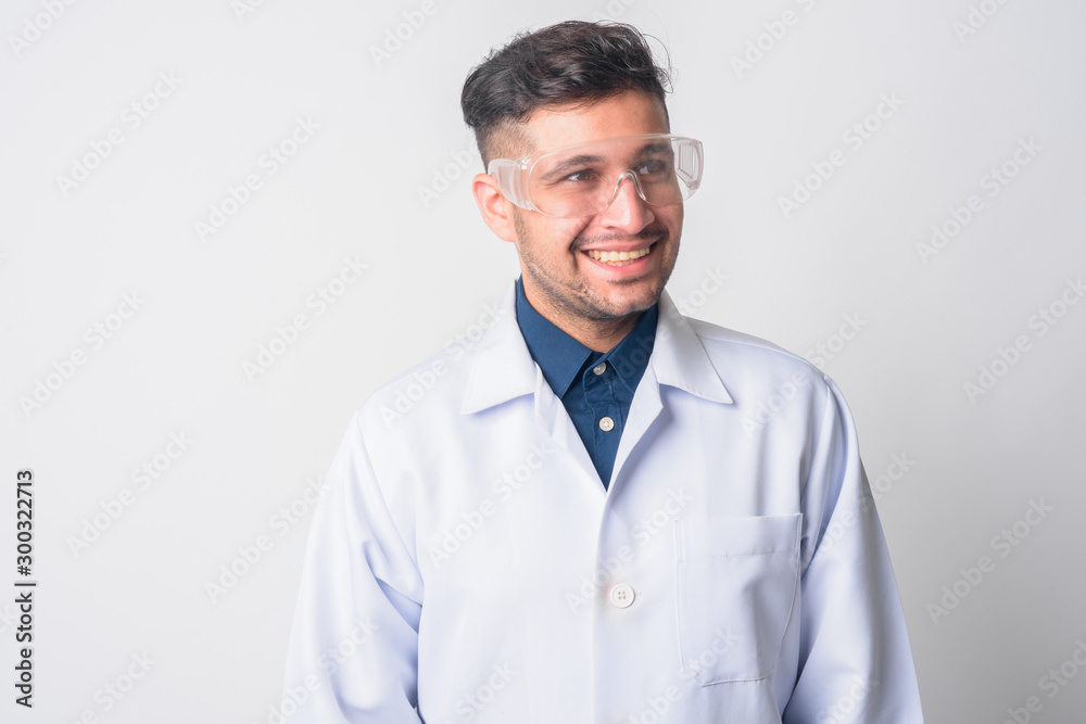 Face of happy Persian man doctor as scientist thinking Face of happy Persian man doctor as scientist thinking