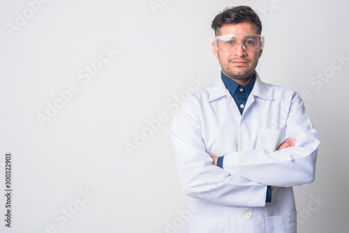 Portrait of young Persian man doctor as scientist with arms crossed photo