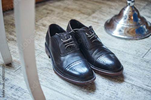 Shoes on a floor. Different accessories of  businessman for creating  style of people lie on wooden background
