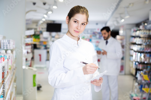 female pharmacist is inventorying medicines