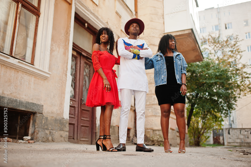 Group of three stylish trendy afro france friends posed at autumn day. Black african man model with two dark skinned womans.