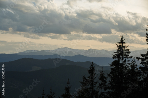 snow-capped peaks of the mountains. clouds walking in the evenings over the mountains