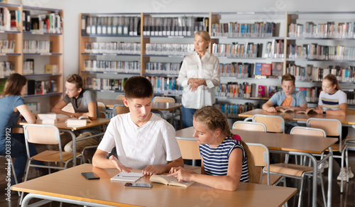 Schoolchildren preparing for lesson in school library