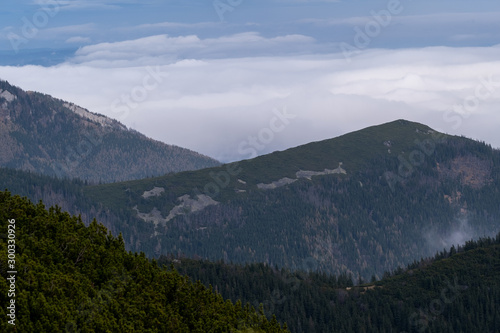 Slovakia view from the top of the tatramountains  where you can see other green mountain peaks that touch the macaques