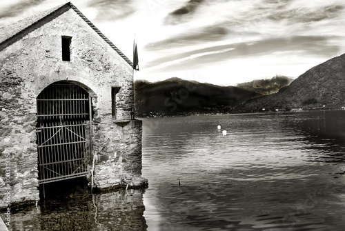 black and white of a house in a lake photo