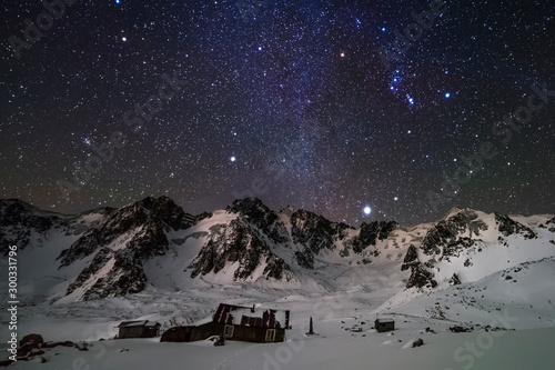 Sirius rising above mountain peaks of Tien Shan in wintertime photo