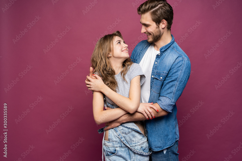Happy loving couple isolated isolated on pink background. Happy loving couple isolated isolated on pink background.