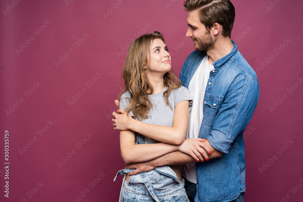 Happy loving couple isolated isolated on pink background. Happy loving couple isolated isolated on pink background.