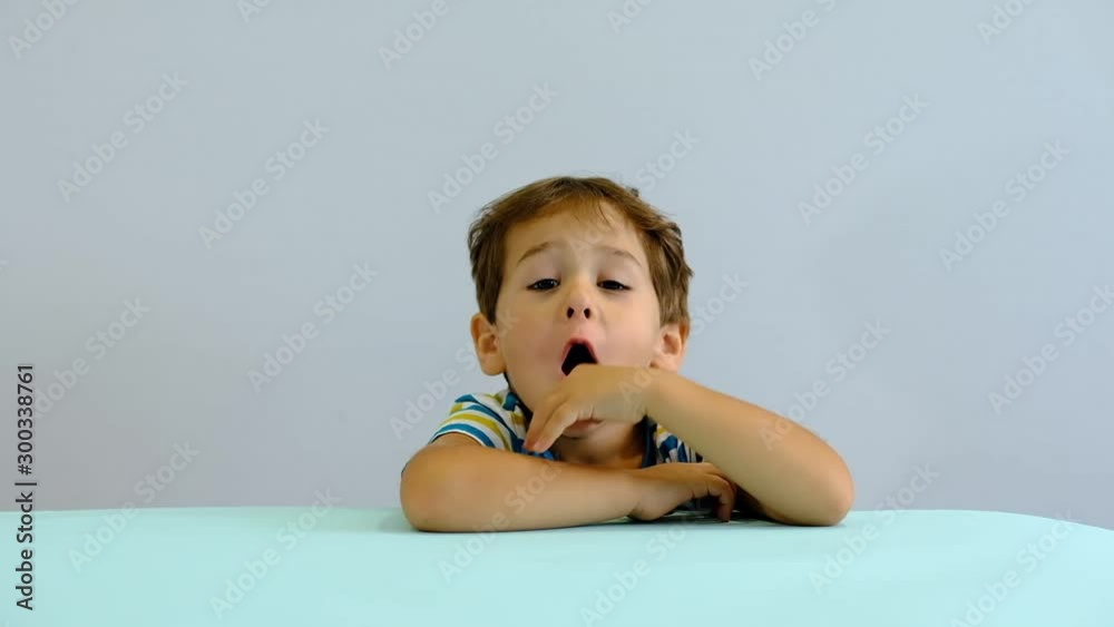 Adorable happy kid baby boy is looking to the camera. Baby looks around and then smiles and laughs. 3 year old fair-haired child smiles at home. Adorable happy kid baby boy is looking to the camera. Baby looks around and then smiles and laughs. 3 year old fair-haired child smiles at home.