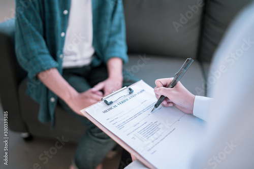 Asian female Doctor and patient are discussing something ,Having Consultation,Medical physician working in hospital writing a prescription, Healthcare and medically concept,selective focus