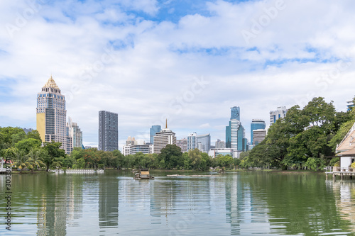 Bangkok business district cityscape from a park with blue sky