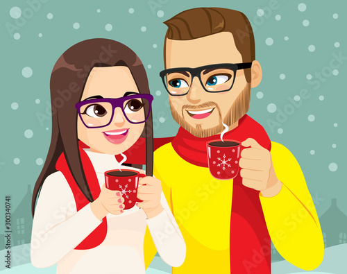 Couple on Christmas winter time holding hot cocoa mug