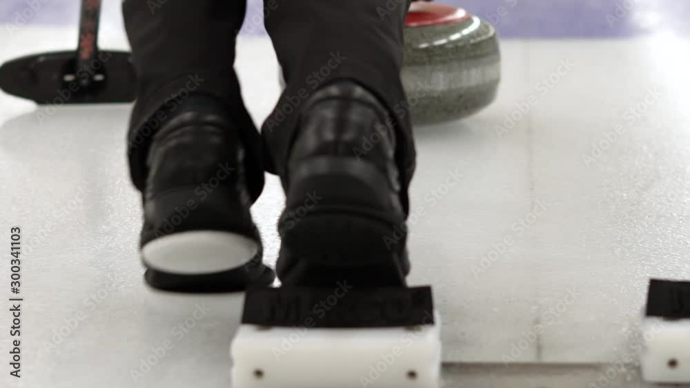 Curler is preparing to start a game. Winter team sport curling. Concept: how to play curling, winter olympic game, indoor games on ice
