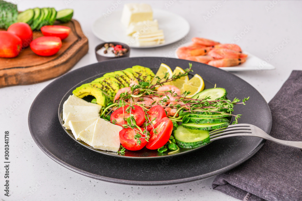 Plate with healthy salad on table