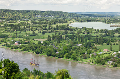 Tall ship Shtandart sailing on the Seine River, through green lush countryside, Armada 2019, Normandy, France photo