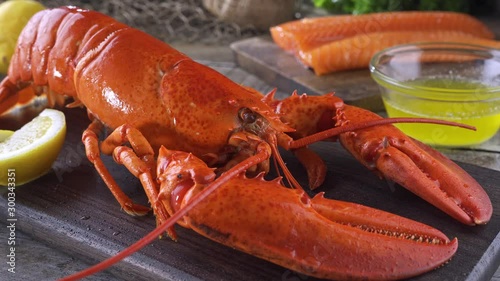 A delicious cooked lobster on a rustic table top.