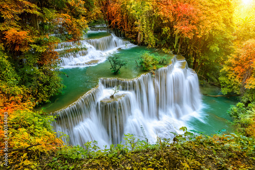 Colorful majestic waterfall in national park forest during autumn - Image