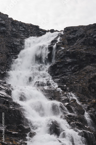 Norwegian Autumn powerful waterfall in the Forest