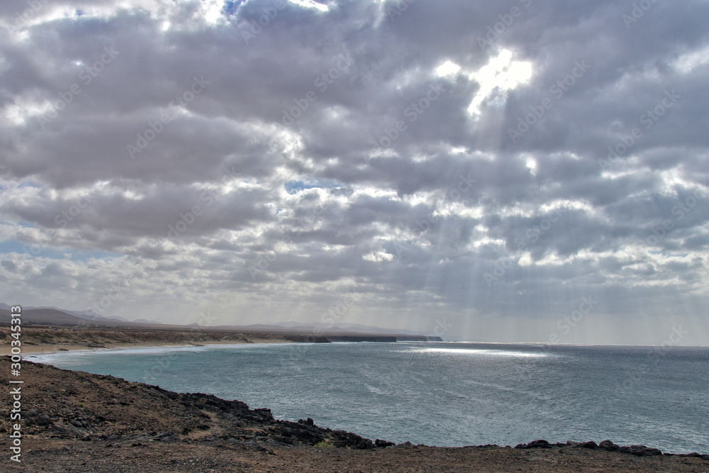 landscape of the Canary Island Fueratentra on the rocks and the ocean and the sky with clouds in January