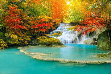 Colorful majestic waterfall in national park forest during autumn