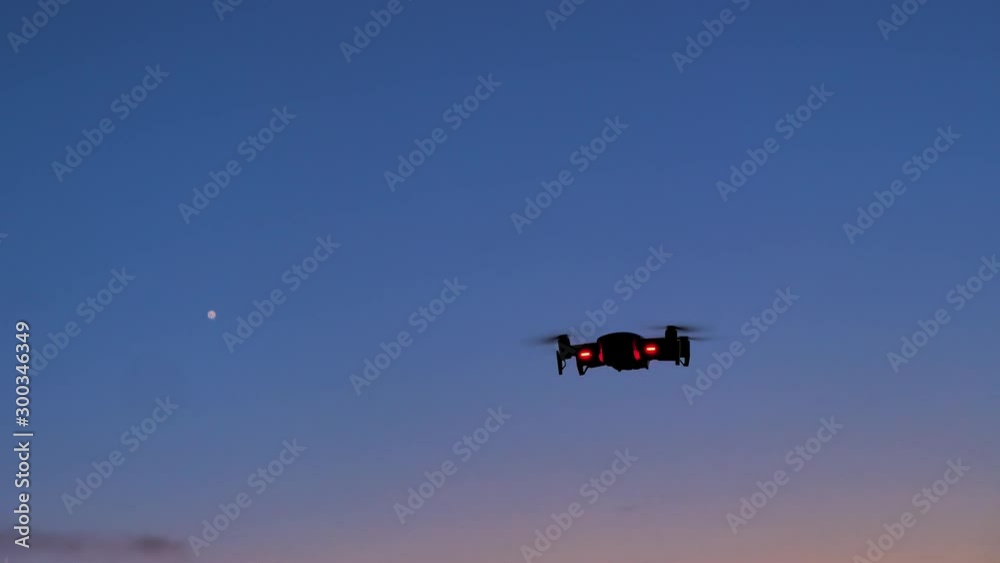 Drone flying to shoot photo and video at the twilight sunset dark and grain processed Drone flying to shoot photo and video at the twilight sunset dark and grain processed