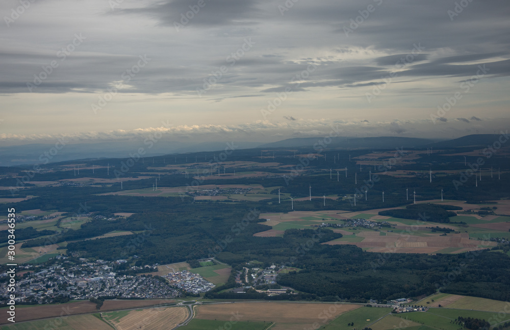  windmills station with propellers generating alternative clean green power in Germany,2019