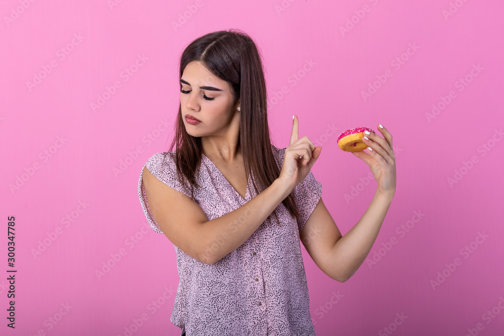 Woman on dieting for good health concept. Close up female using hand push out her favourite donut for good health. Diet, dieting concept. Junk food, Slimming, weight loss