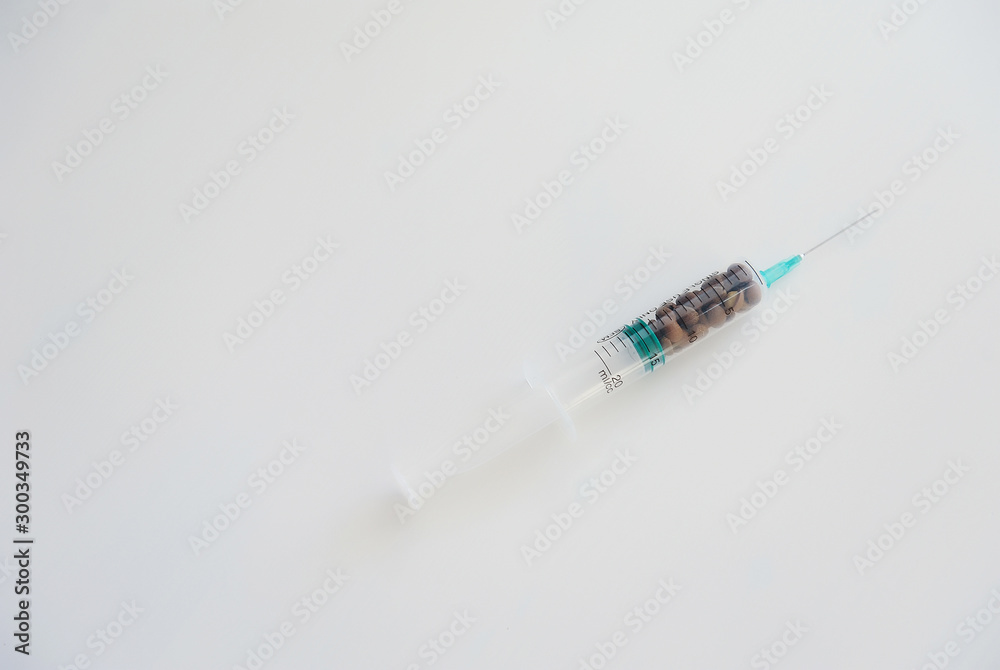 Coffee beans in a medical syringe. Caffeine addiction symbol Coffee beans in a medical syringe. Caffeine addiction symbol