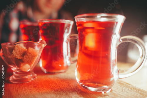 3 cups of black hot tea on table on dark background