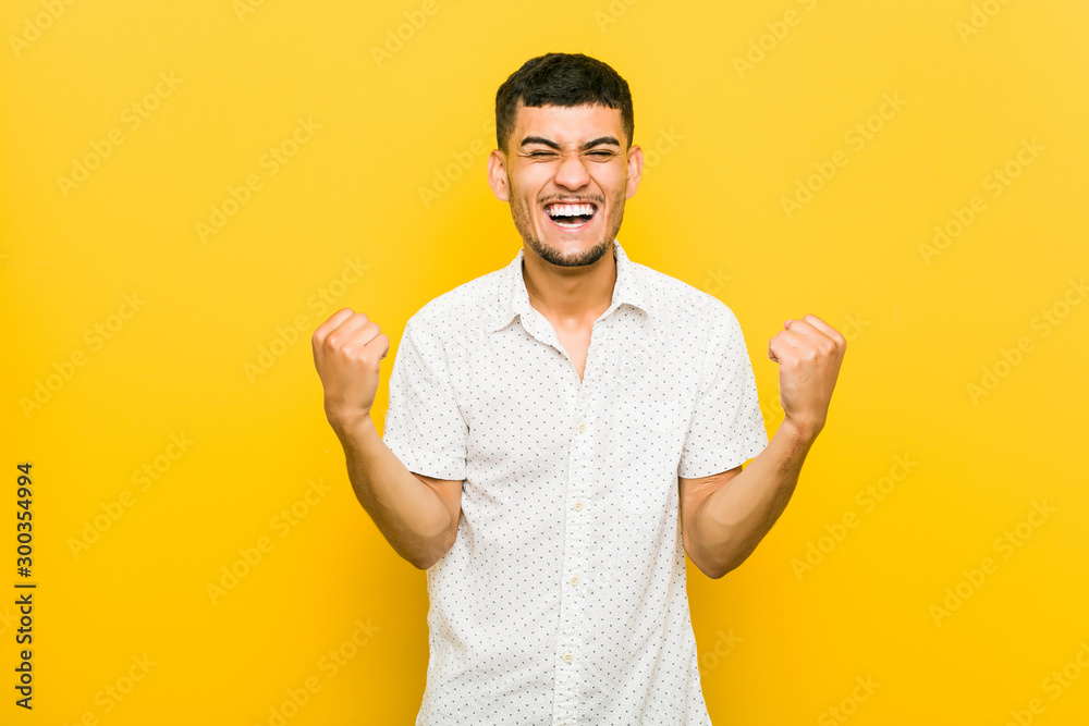 Young hispanic man cheering carefree and excited. Victory concept.